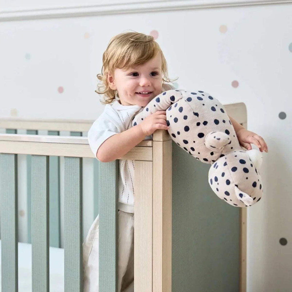 Wooden cot bed rail with sage panel and vertical slats, golden oak frame