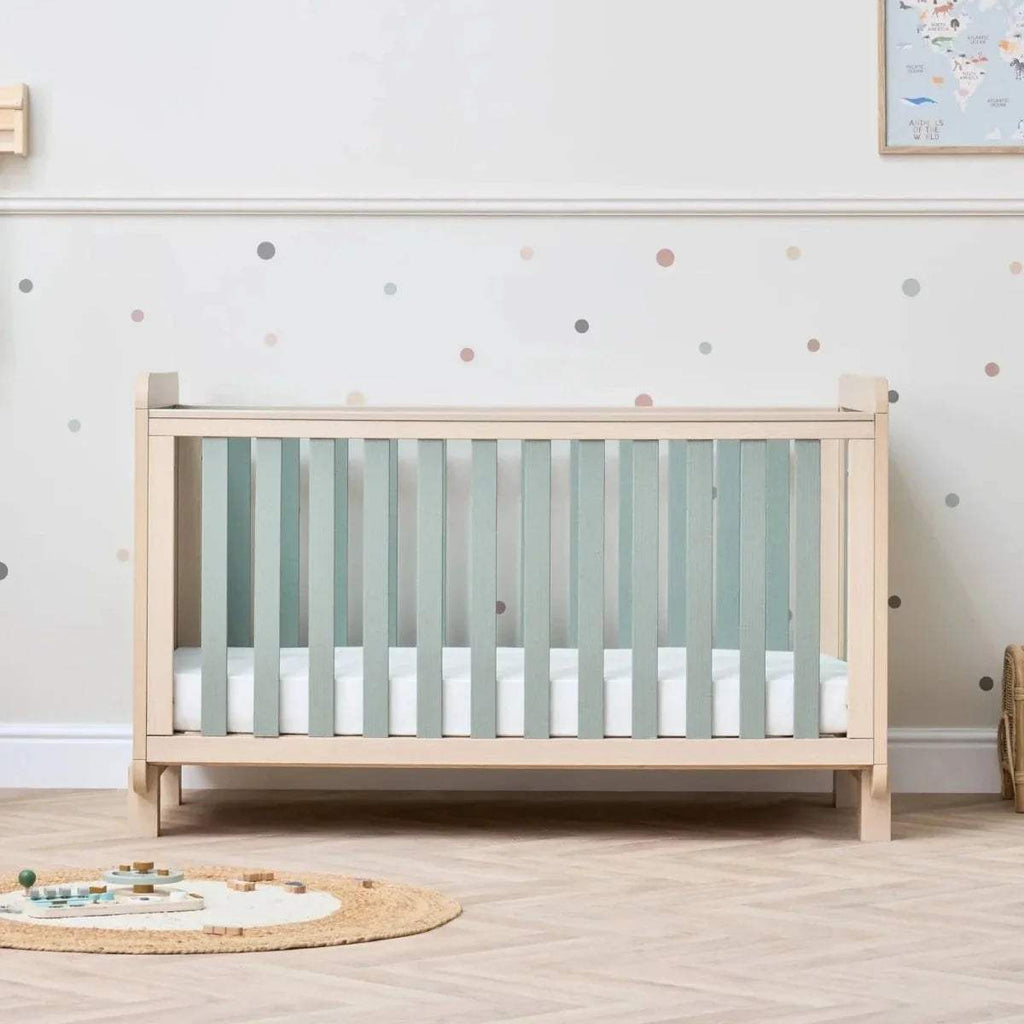 Golden oak cot bed with sage mattress area and vertical side slats