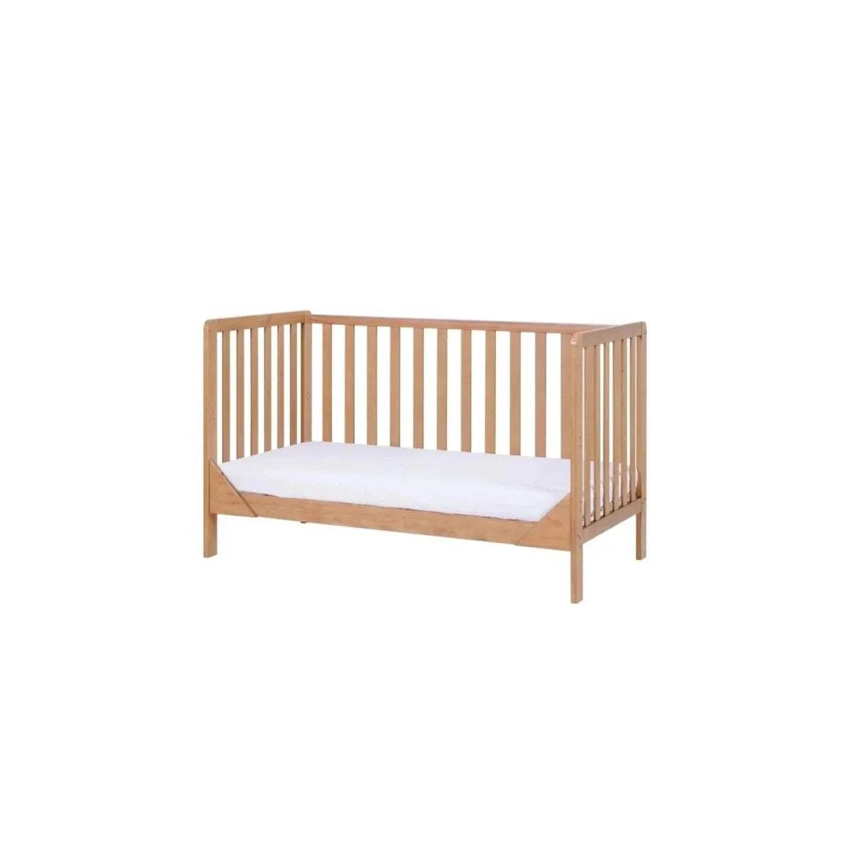 Wooden cot bed with vertical slat rails and white mattress pad