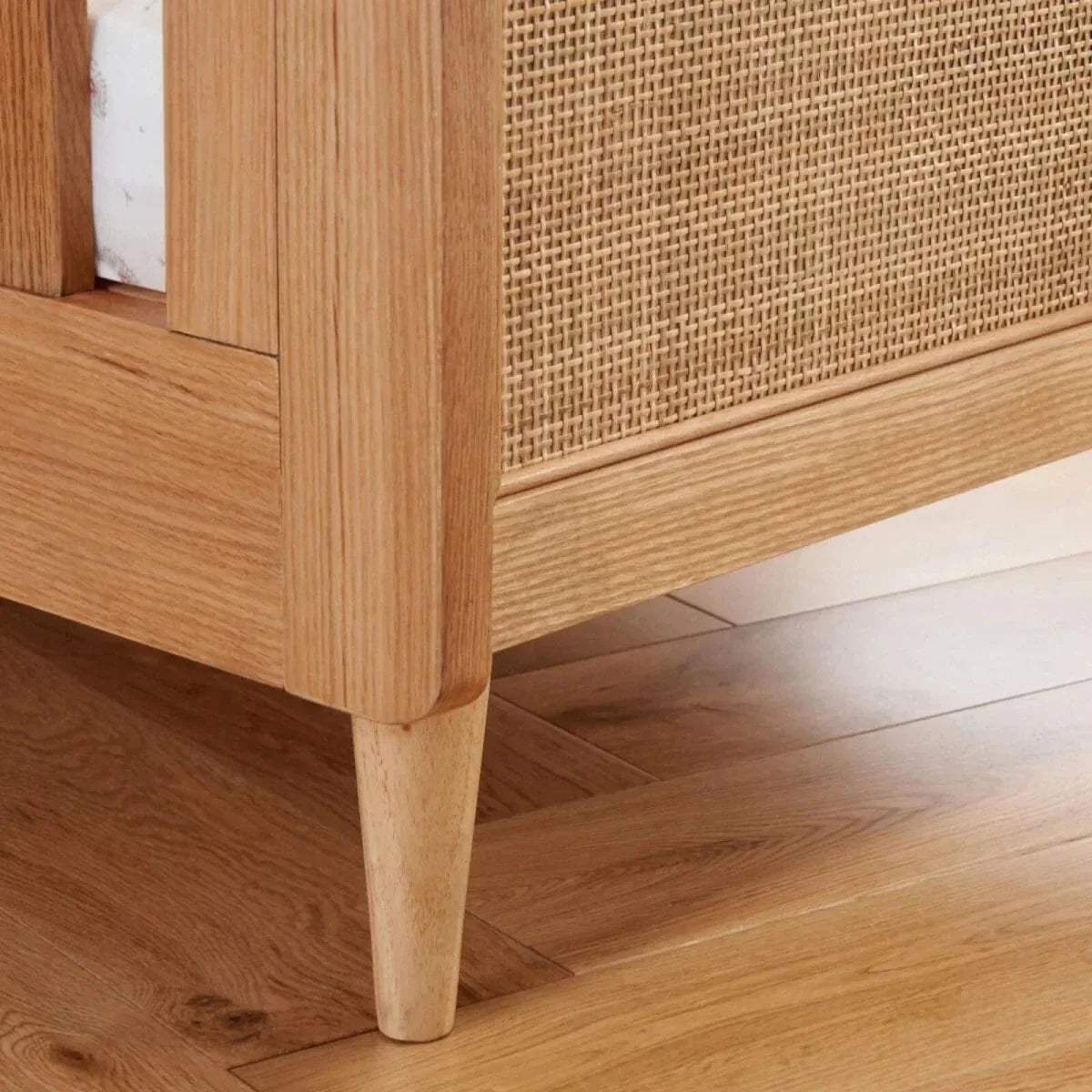 Light oak cot bed corner leg and woven side panel detail