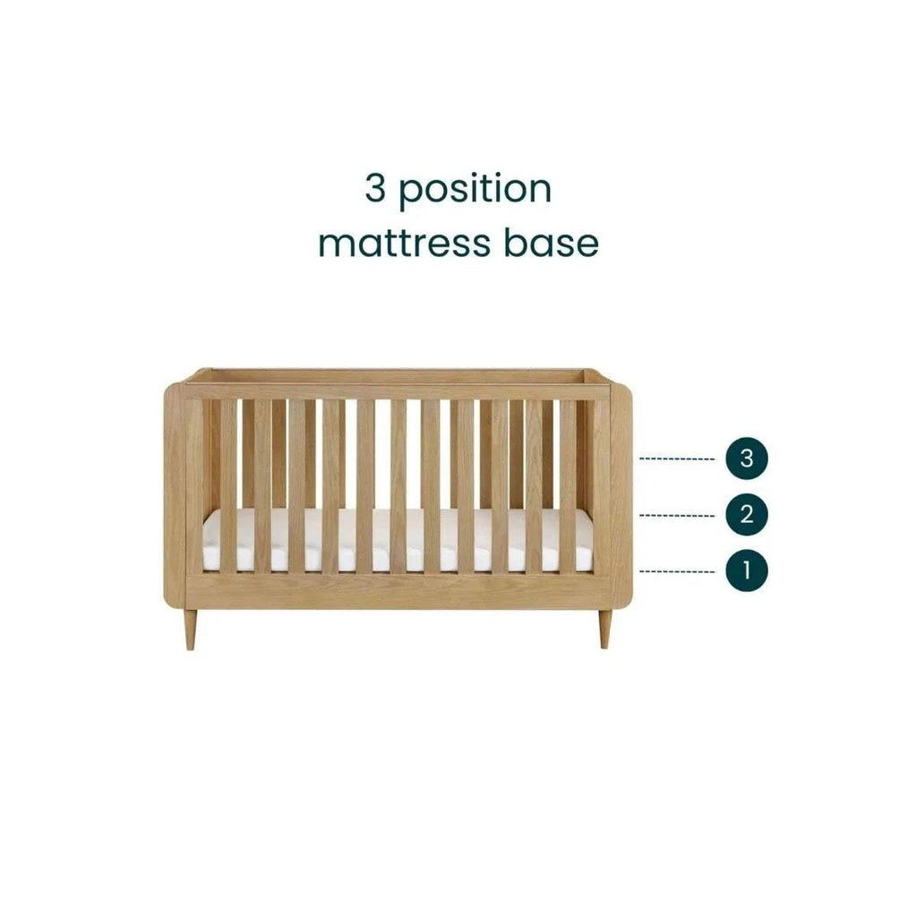 Light oak cot bed mattress area with vertical slat rail and tapered legs