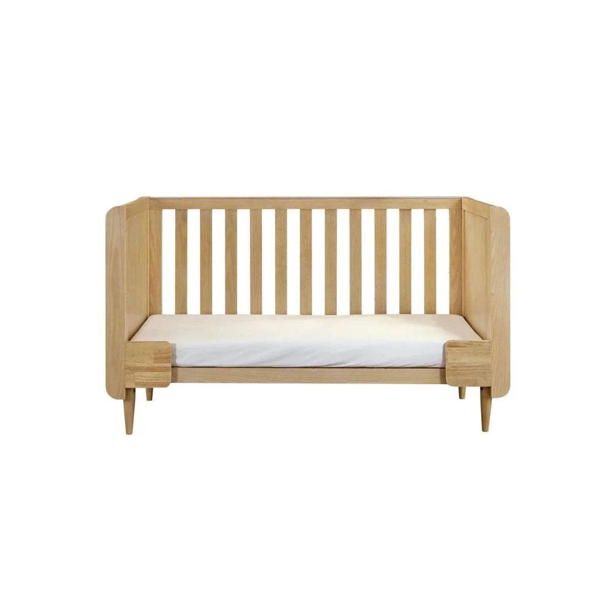 Light oak cot bed with vertical slatted headboard and matching side rails