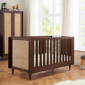 Warm walnut baby cot bed with woven side panel and vertical slat guard rail