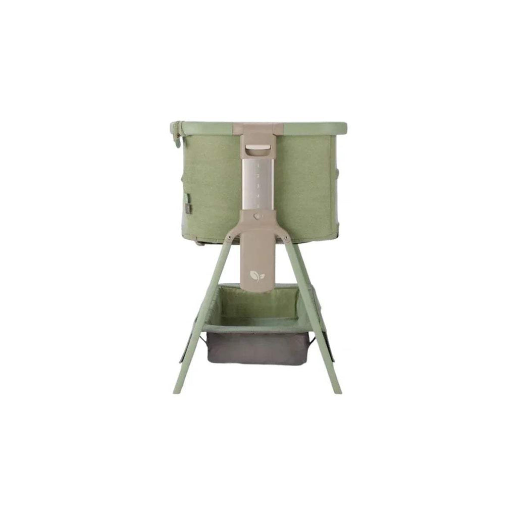 Eucalyptus green bedside crib with rear fabric panels and adjustable leg frame
