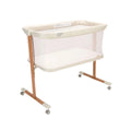 Ecru crib with walnut legs, mesh sides, padded mattress base, and caster wheels