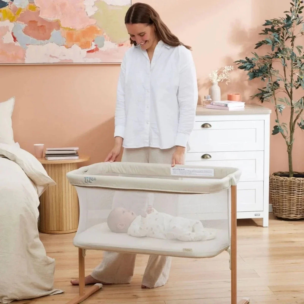 Ecru and walnut crib with mesh sides and padded mattress base