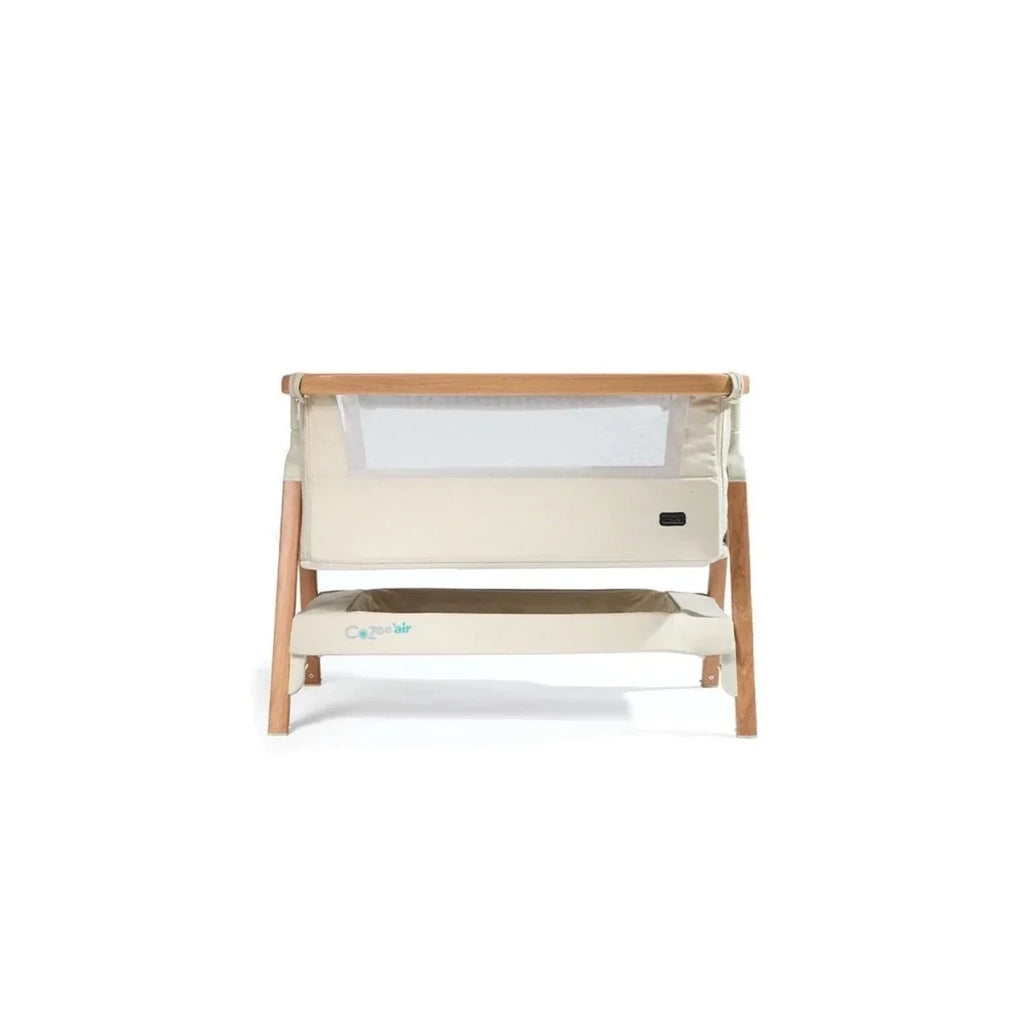 Ecru bedside crib front view with mesh panel and walnut legs