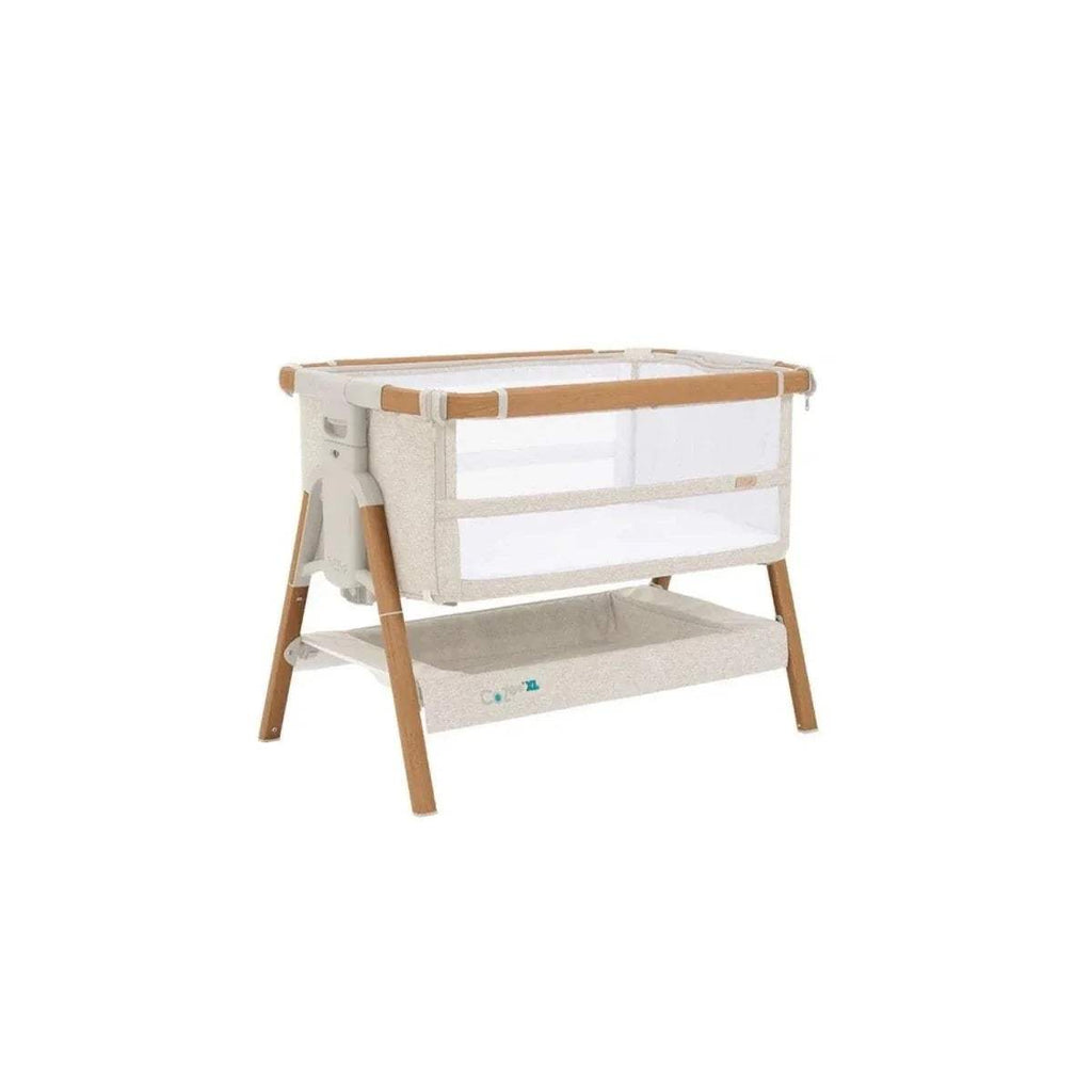 Walnut and ecru bedside crib with open side panel, mesh rail, and four wooden legs