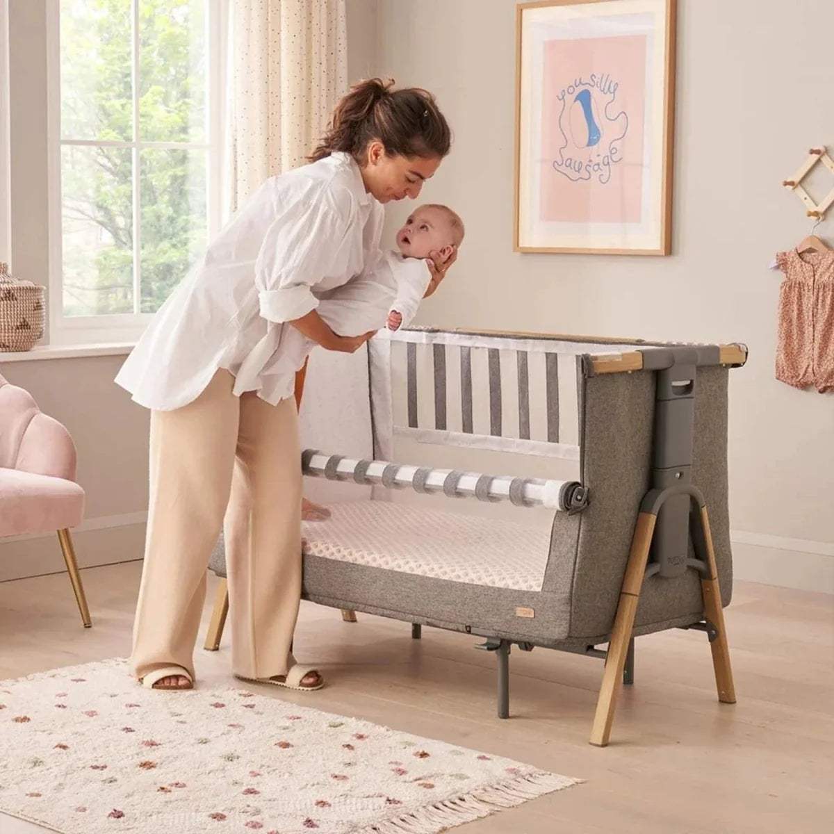 Wood and grey bedside crib with striped fabric panel and enclosed base