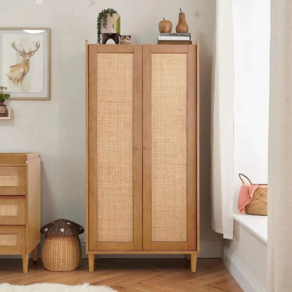 Light oak wardrobe with two doors, woven panels, and slim tapered legs