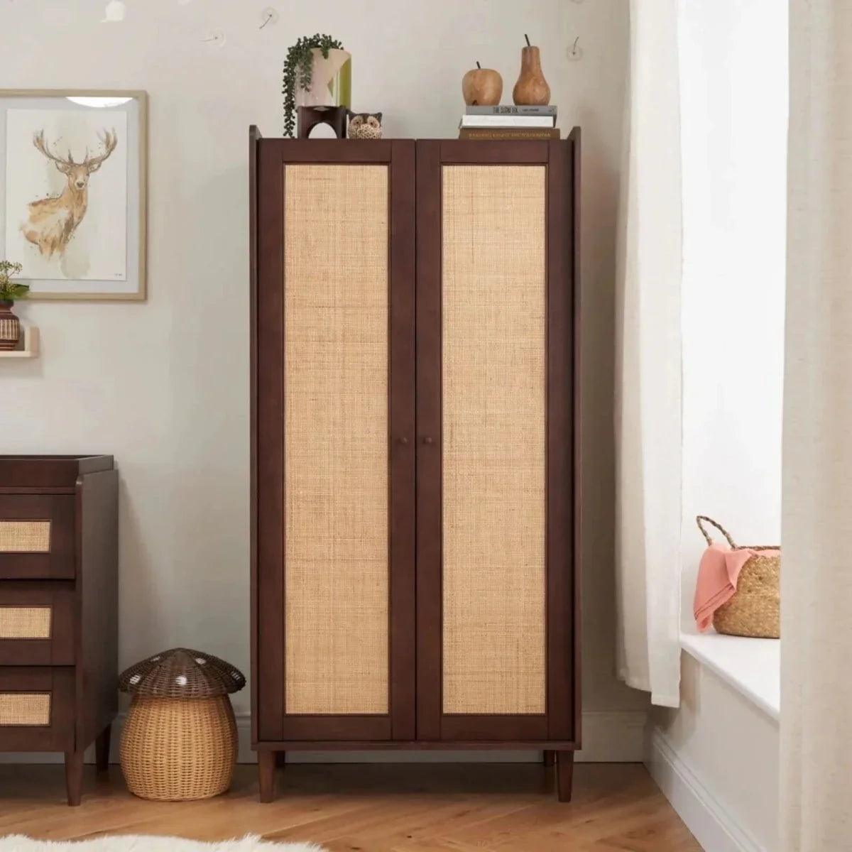 Warm walnut wardrobe with two woven rattan-style doors and four tapered feet