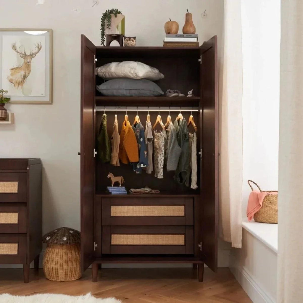 Warm walnut wardrobe open with top shelf, hanging rail, and two woven drawer fronts