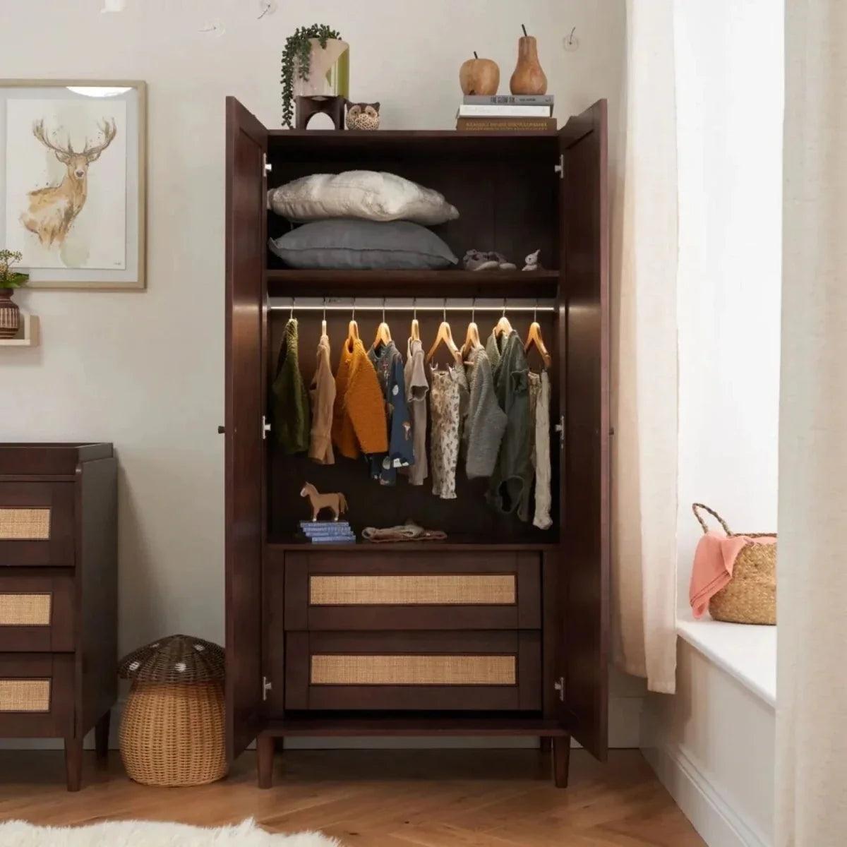 Warm walnut wardrobe open with top shelf, hanging rail, and two woven drawer fronts