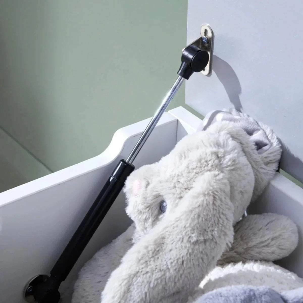 Toy box interior with white plush toy and dove grey back panel