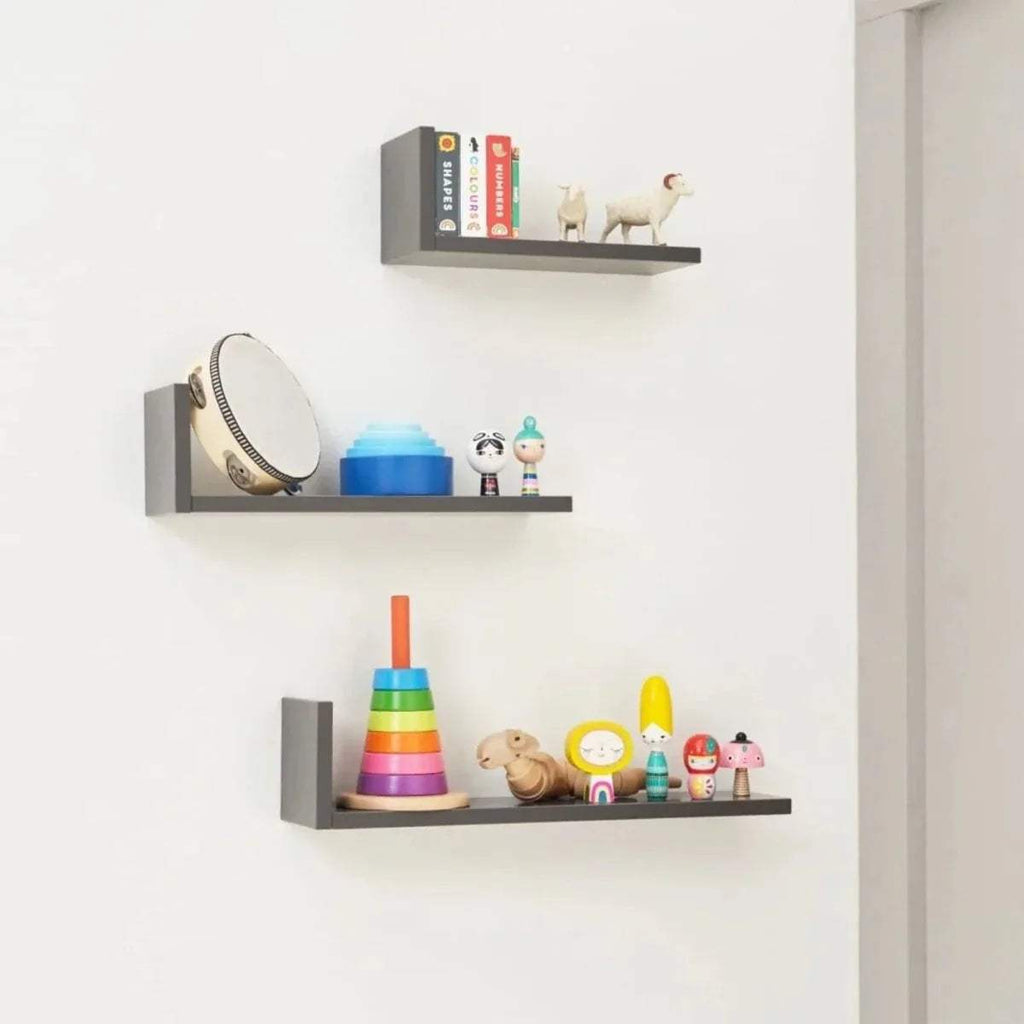 Three slate grey L-shaped wall shelves with open front sides