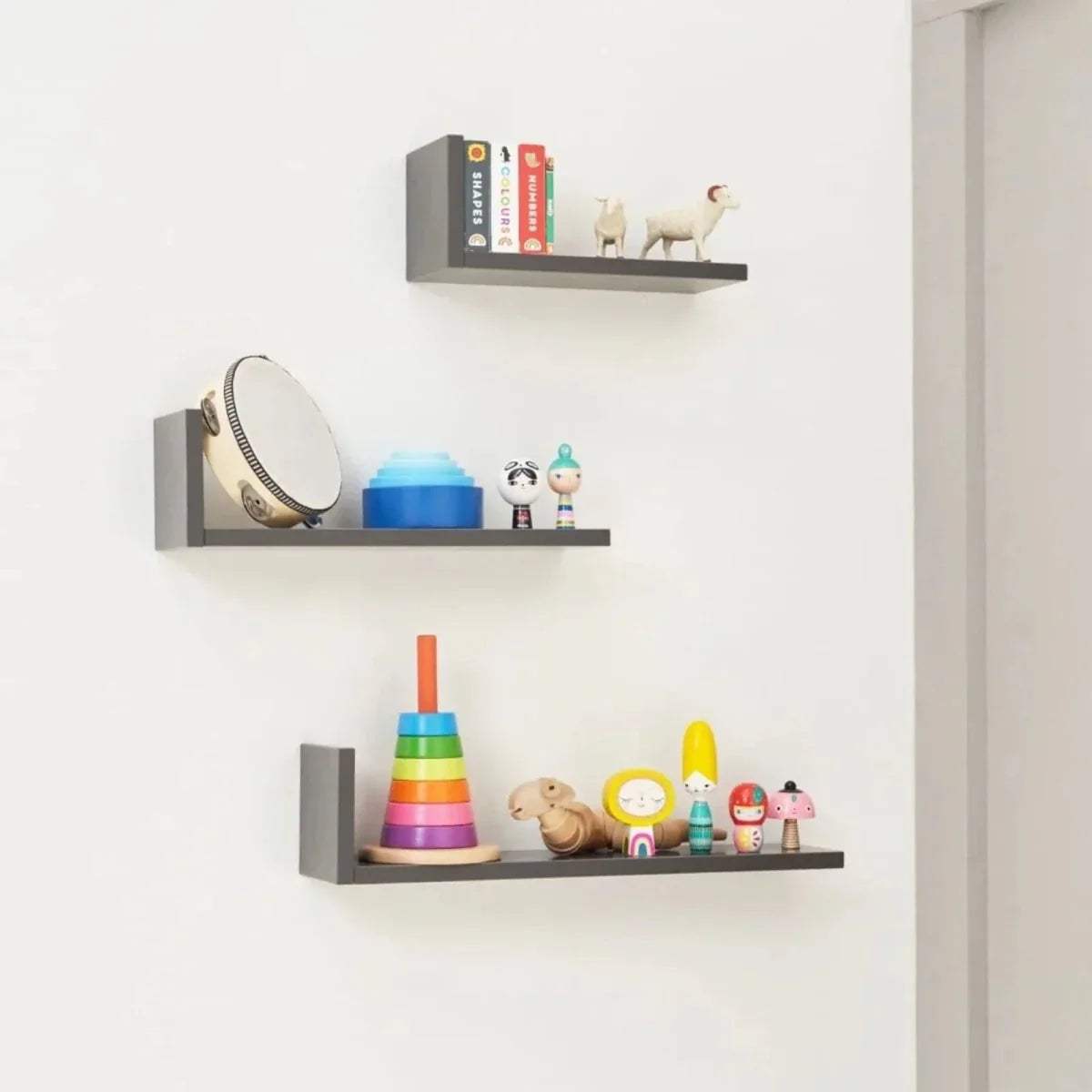 Three slate grey L-shaped wall shelves with open front sides