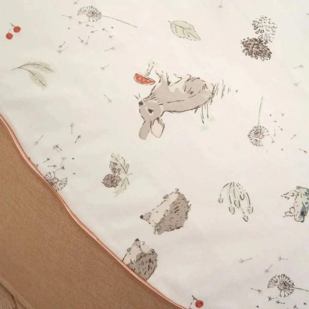 White beanbag fabric panel with gray animal and dandelion prints, beige trim edge