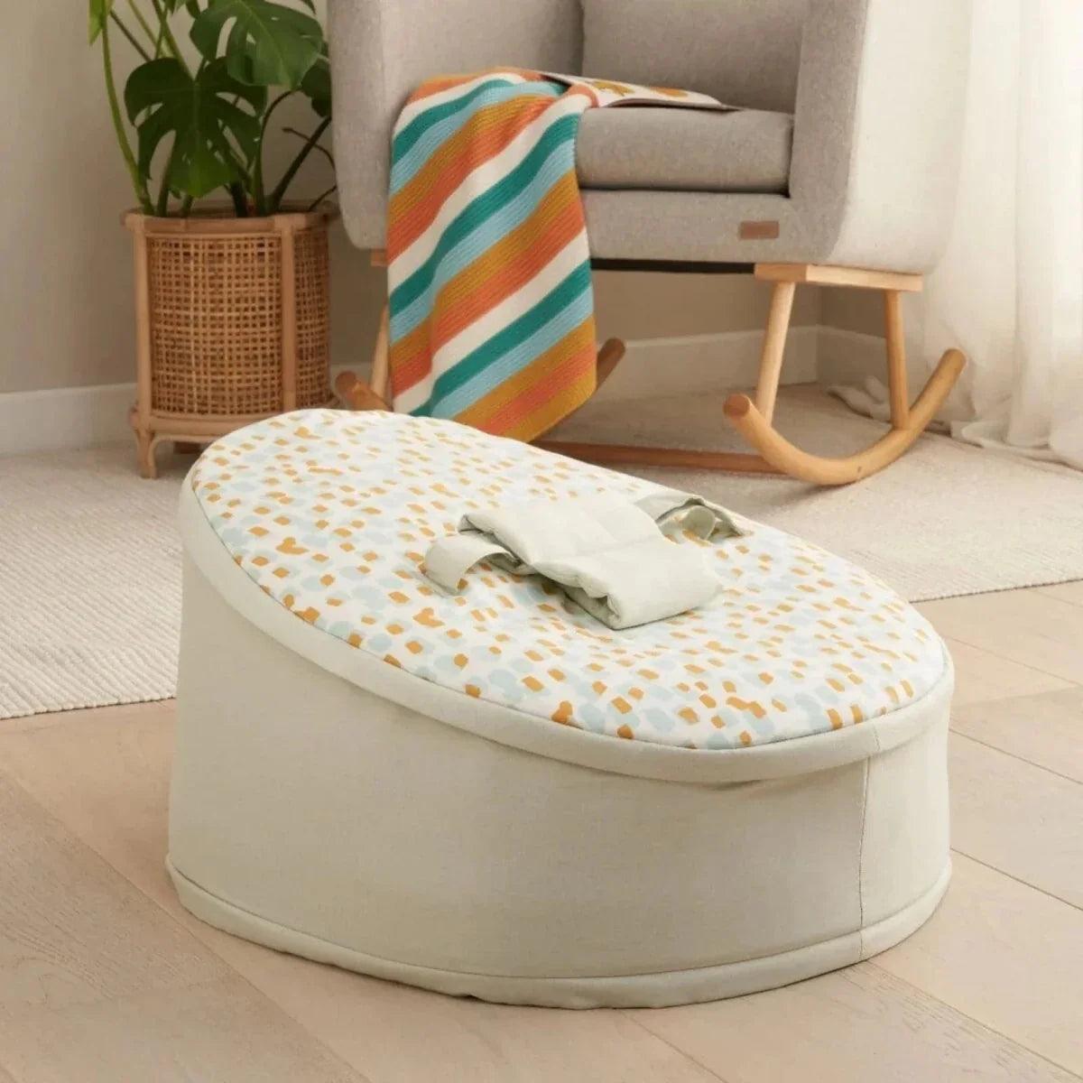 Baby beanbag with cream jungle animal print top and light gray rounded base