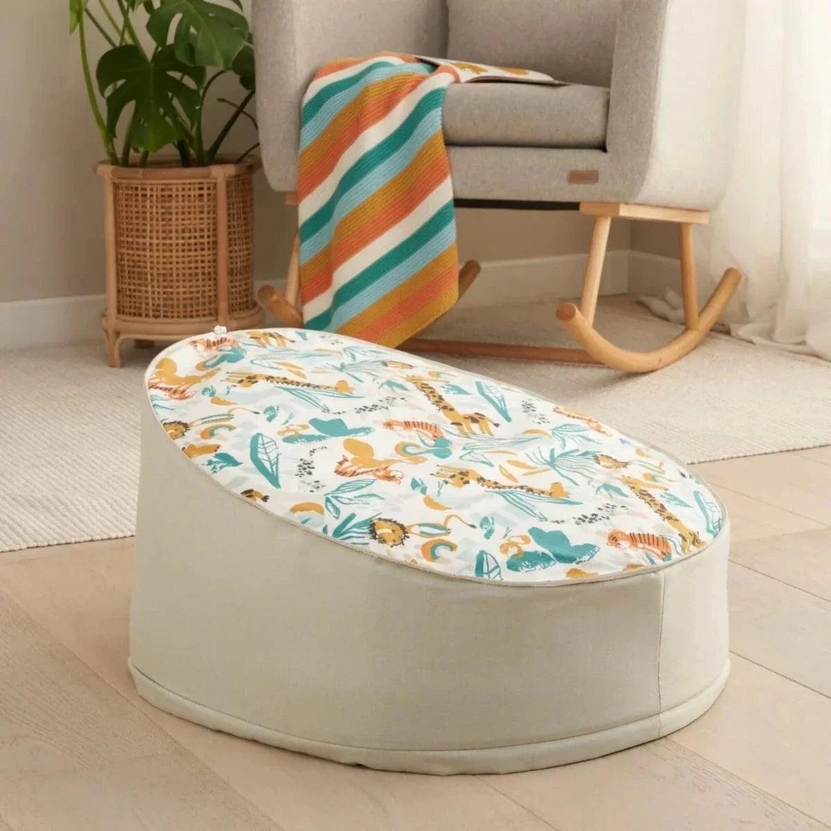 Baby beanbag in cream jungle animal print with light gray sides and rounded shape