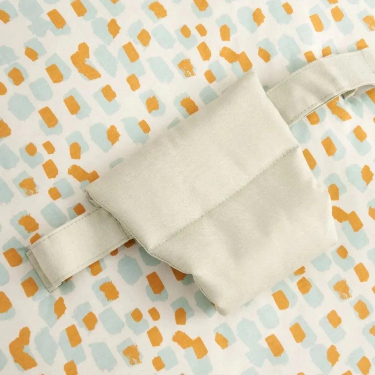 Close-up of baby beanbag side panel with fabric flap and light gray trim