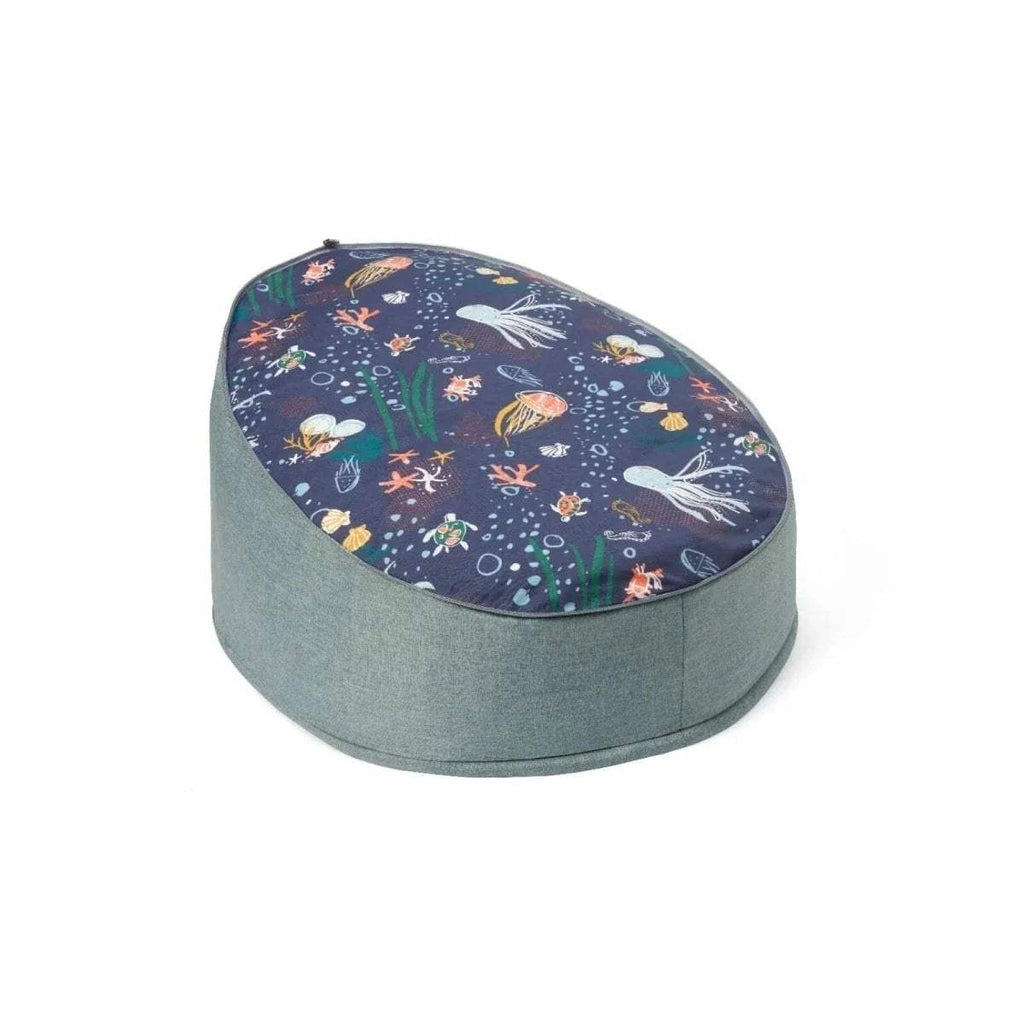 Round baby beanbag with gray fabric base and dark navy sea-creature patterned top.