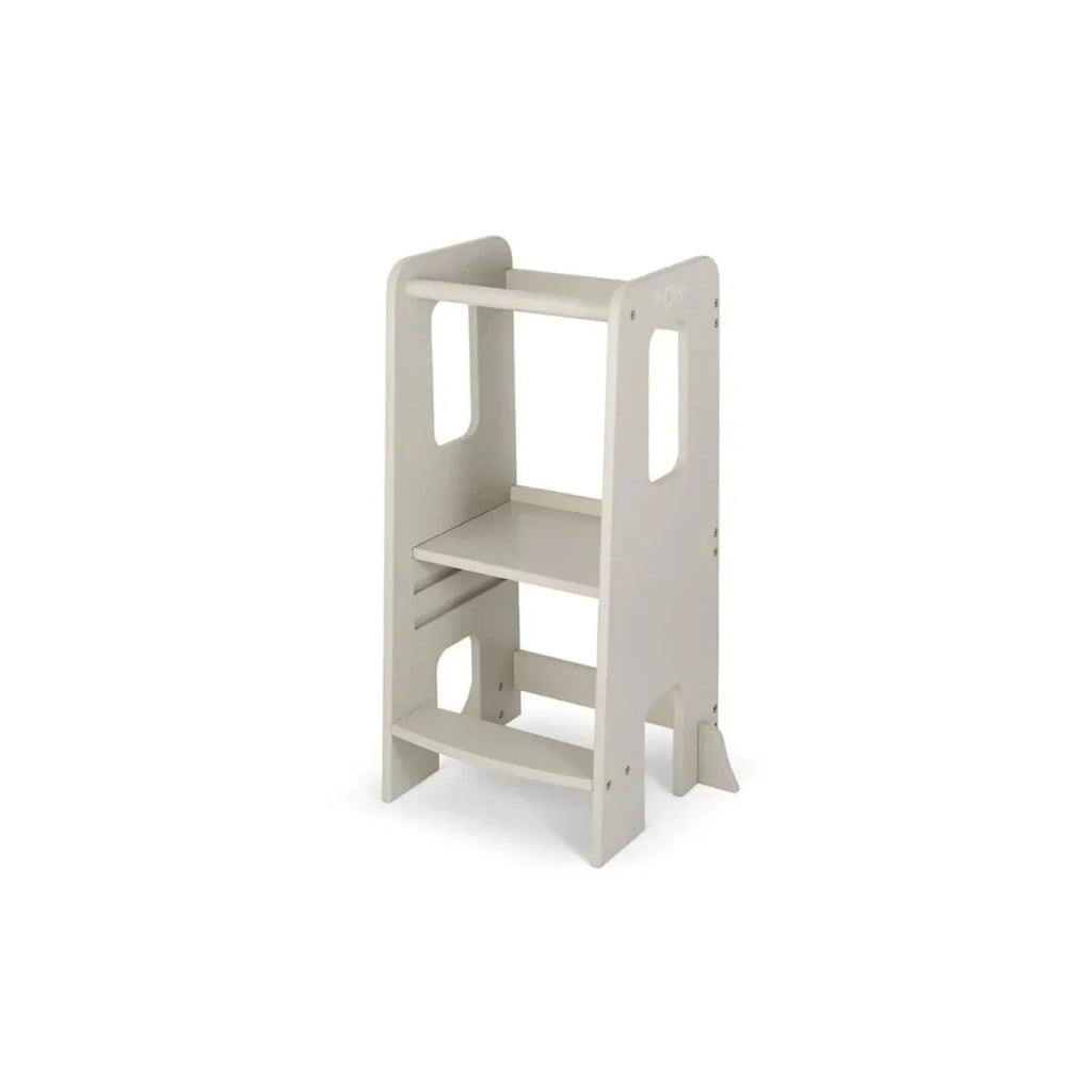 Light beige Montessori-style learning tower with side cutouts and two interior shelves
