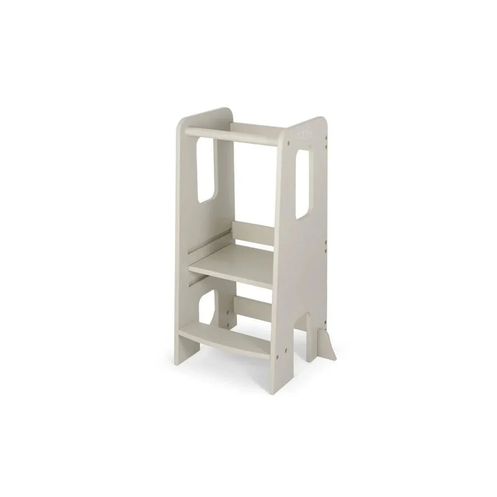Light beige toddler learning tower viewed from the side with open step shelves