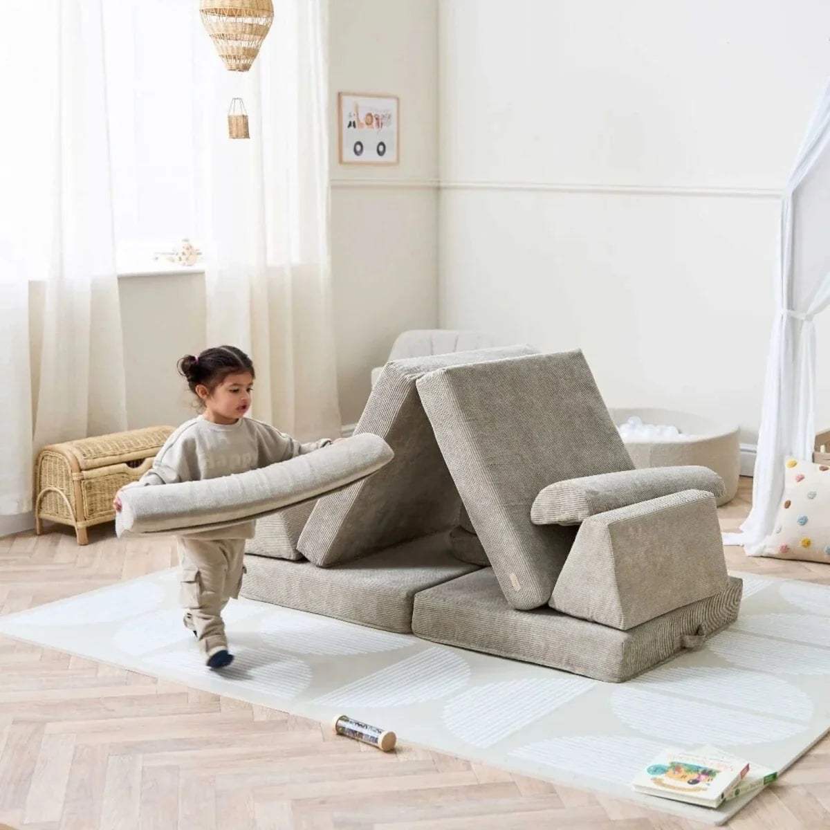 Mushroom-beige play sofa with soft blocks and angled panels for kids’ climbing play