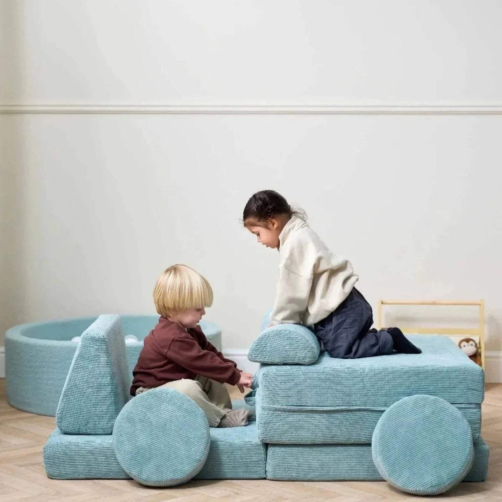 Kids play sofa with children on the seat and round front cushions, teal fabric