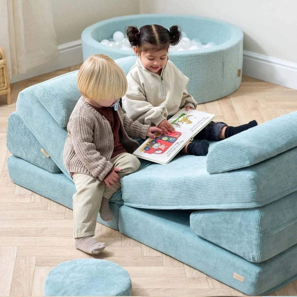 Teal kids play sofa with children reading on the seat and side bolster cushions