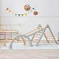 Montessori pikler climbing frame with gray supports and wooden rungs plus climbing wall