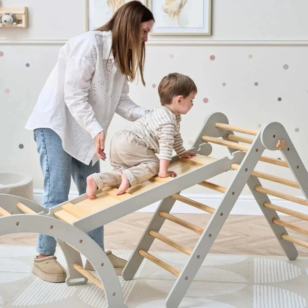 Montessori pikler climbing frame with gray side supports and wooden steps for climbing