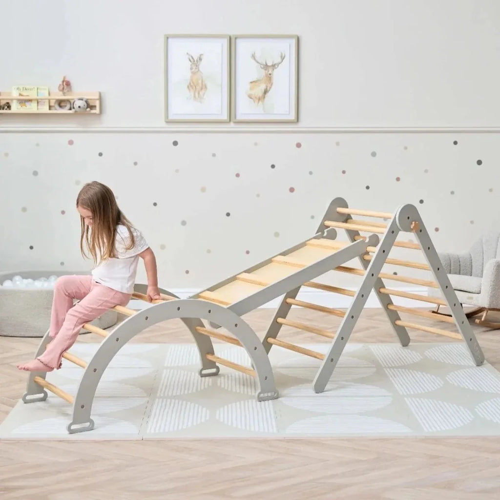Montessori pikler climbing frame with gray arch base and slanted wooden ladder