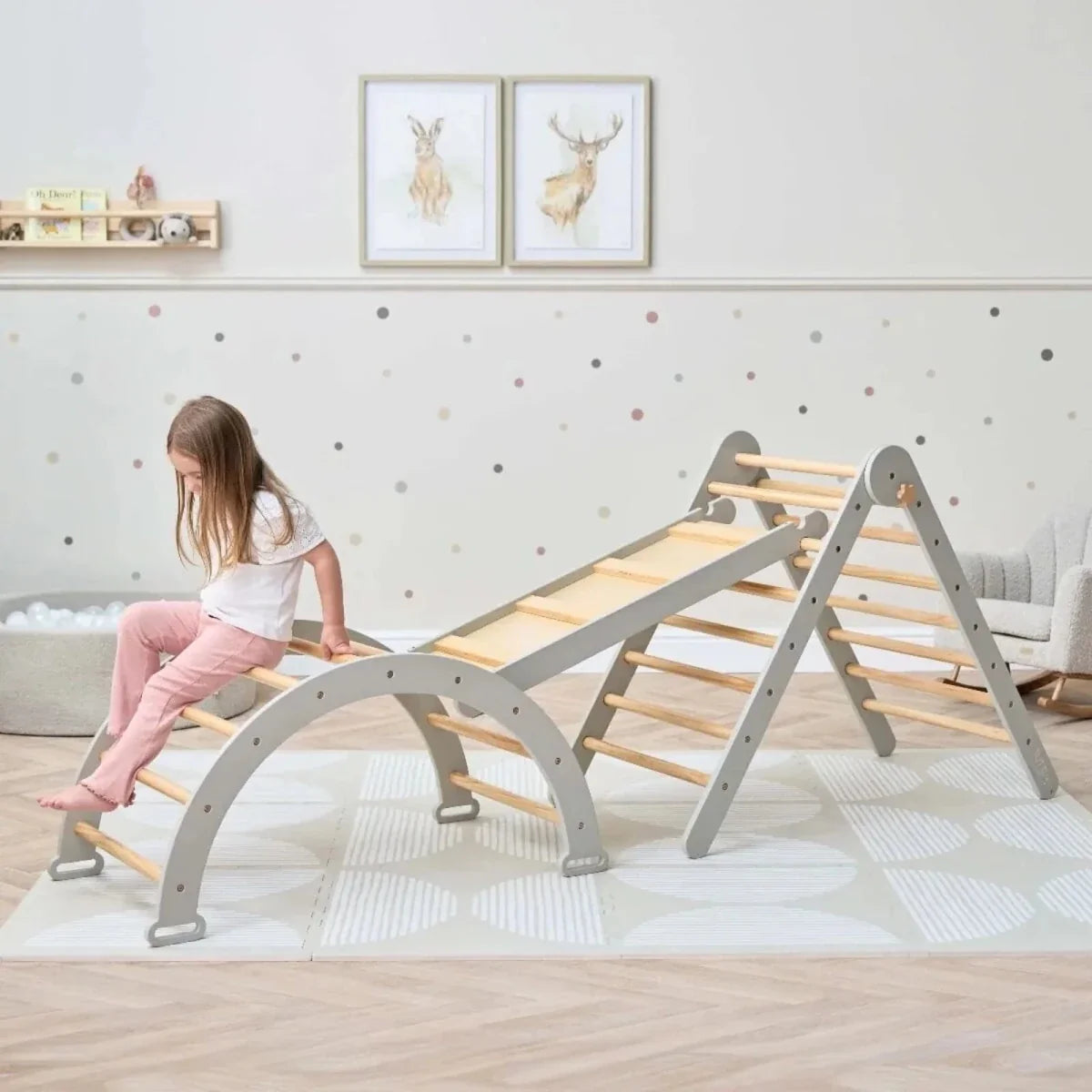 Montessori pikler climbing frame with gray arch base and slanted wooden ladder