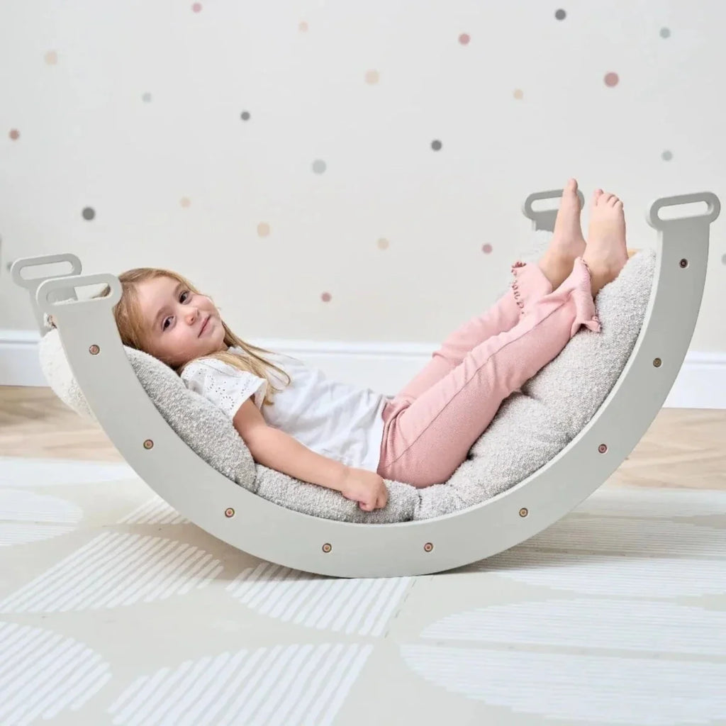 Gray semi-circular rocking arch with handles for climbing frame play