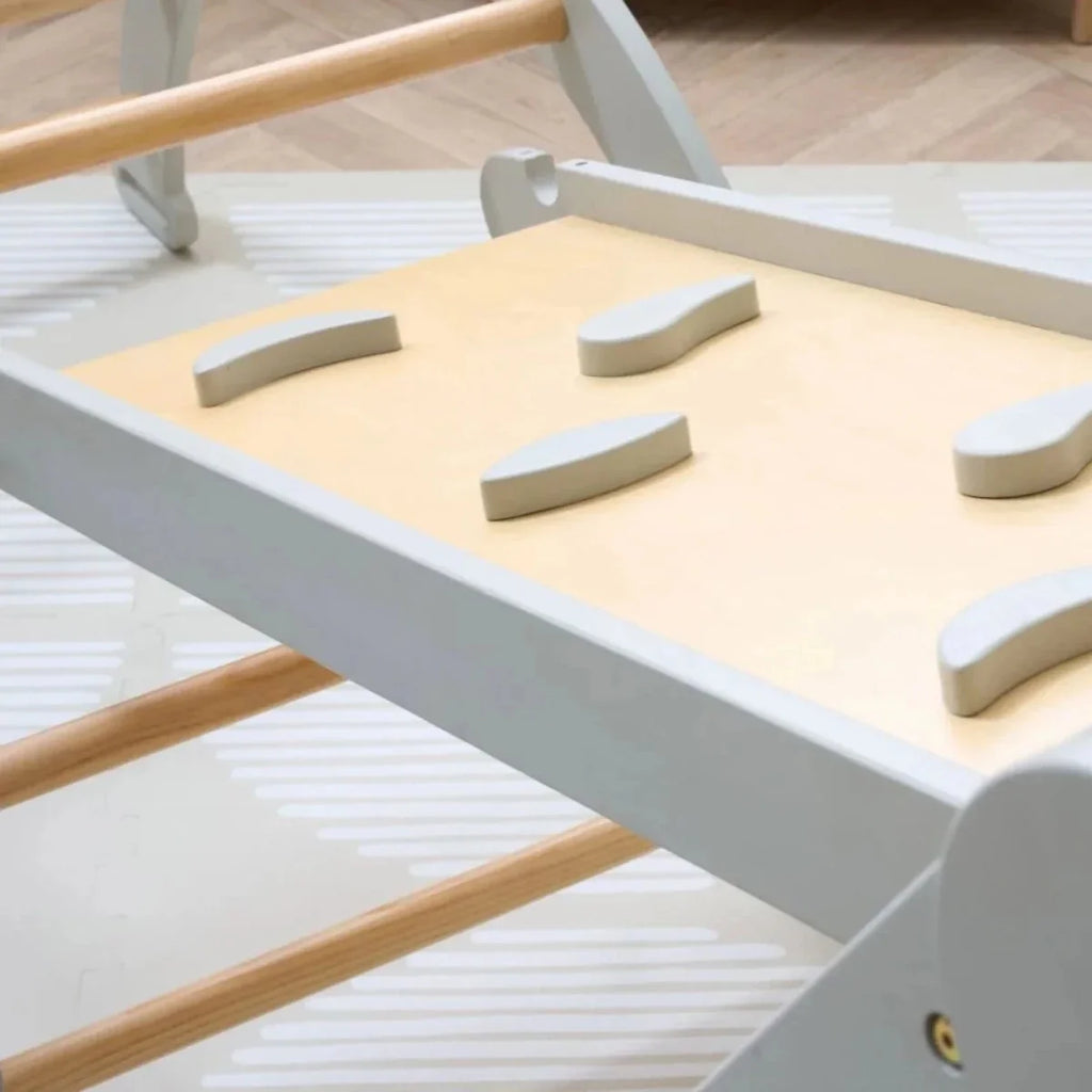 Detail of wooden climbing surface with gray supports and rounded corner stops