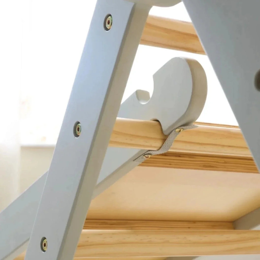 Close view of pikler climbing frame with curved grey grip and light wood rungs