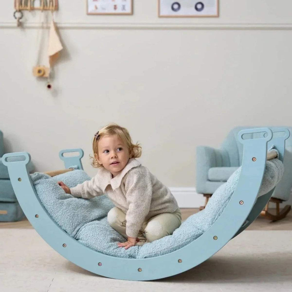 Ocean stone Pikler rocking hammock seat with child, padded fabric and curved frame