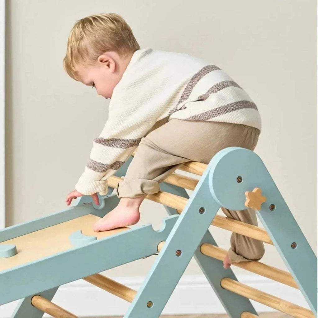 Ocean stone climbing frame detail with wooden rungs on angled ladder panel