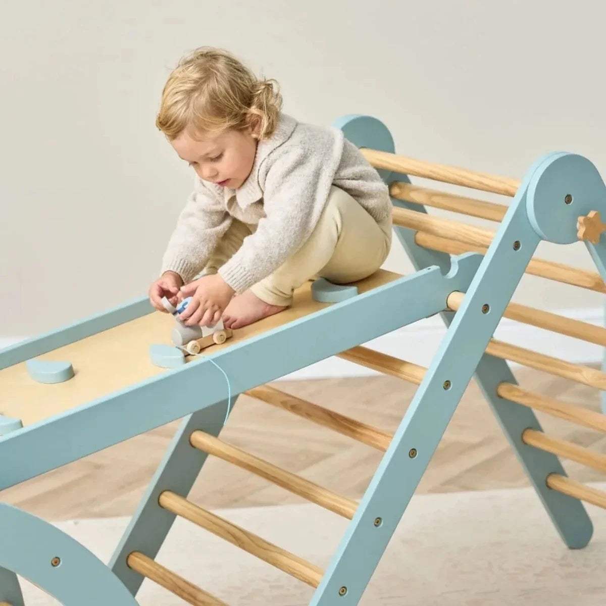 Ocean stone pikler climbing ramp with wooden rungs and angled ladder side panel
