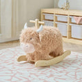 Highland cow rocking toy with beige plush body, white muzzle, and wooden rocker base.