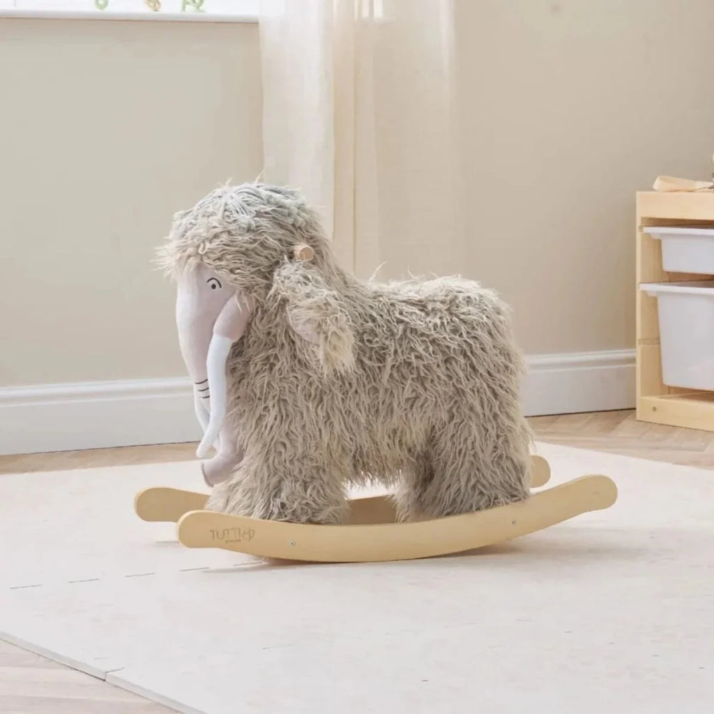 Gray plush woolly mammoth rocking toy with curved wooden base.