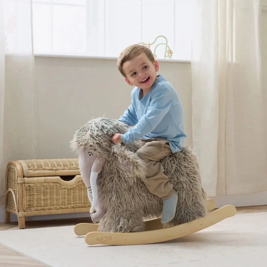 Gray plush woolly mammoth rocking toy, seated pose on curved wooden rockers.