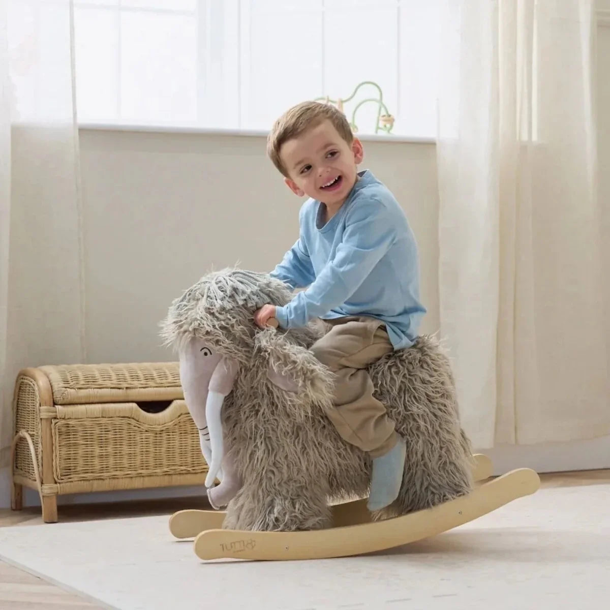 Gray plush woolly mammoth rocking toy, seated pose on curved wooden rockers.