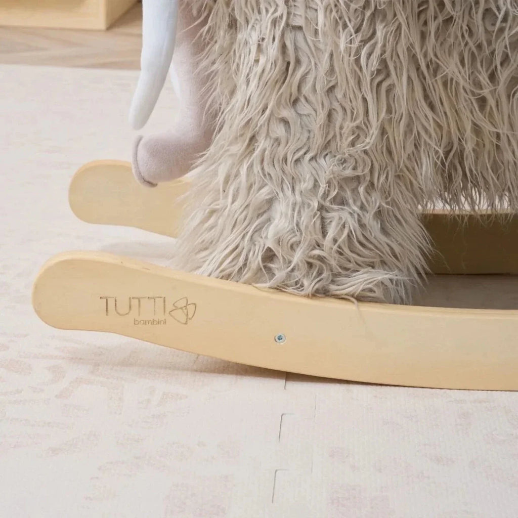 Wooden rocking base on gray plush woolly mammoth toy, logo on rail.