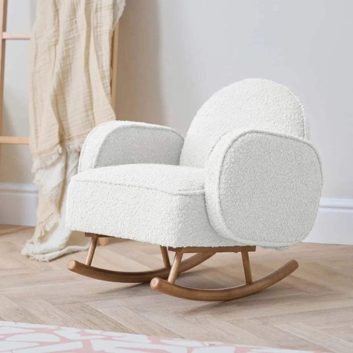 Kids rocking chair in cream teddy upholstery with rounded armrests and rocking base