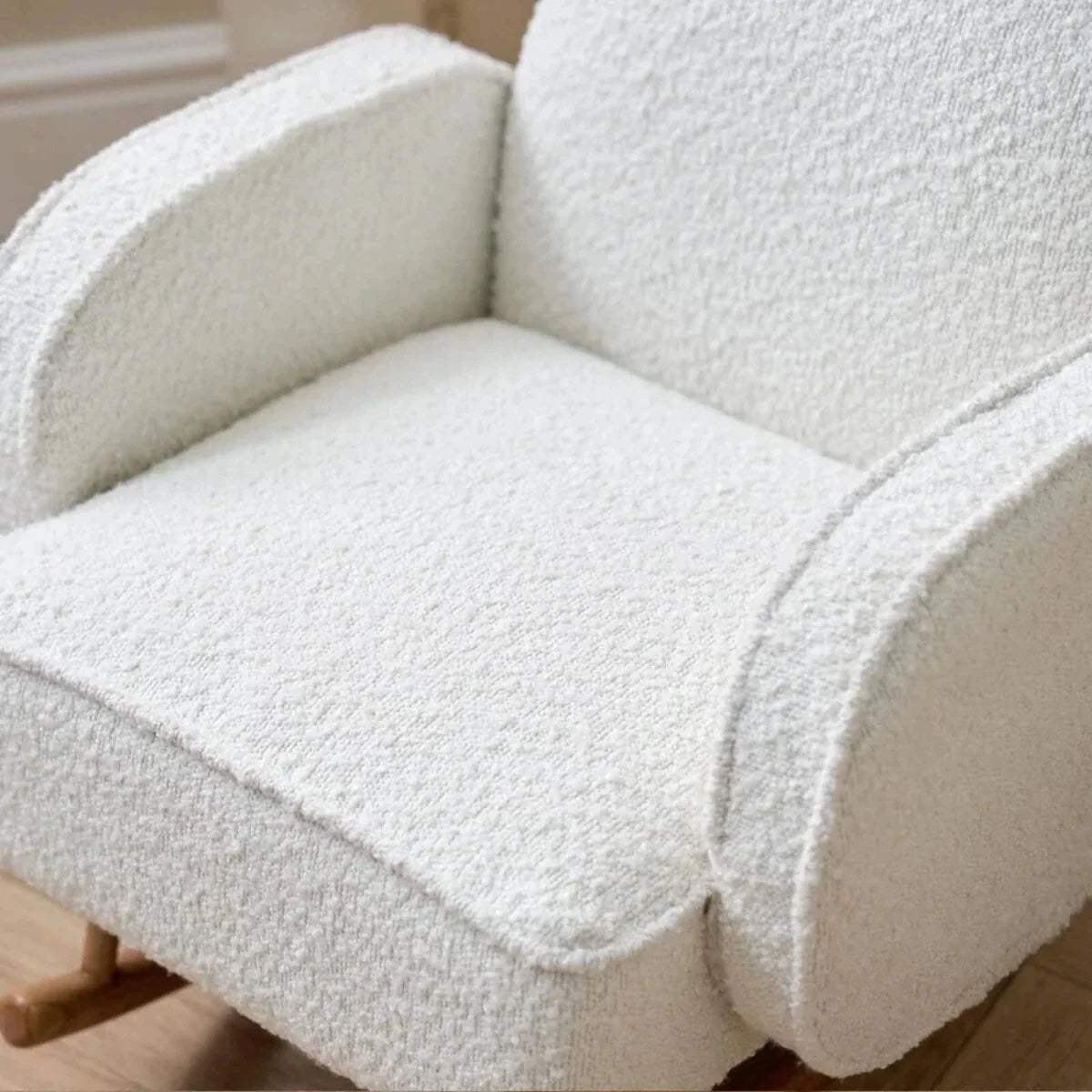 Kids rocking chair with plush cream seat cushion and curved arm and backrest