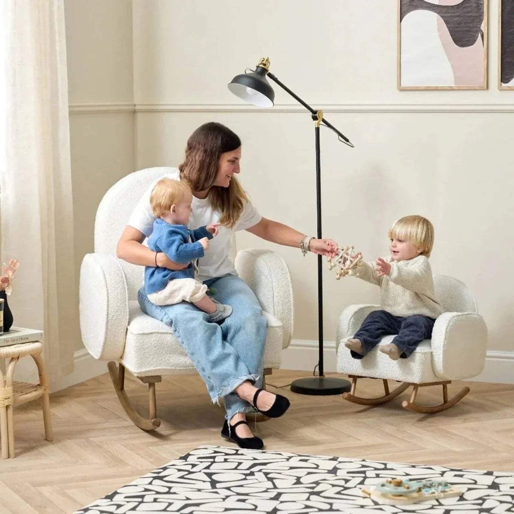 Kids rocking chair with two children sitting on cream upholstered rockers