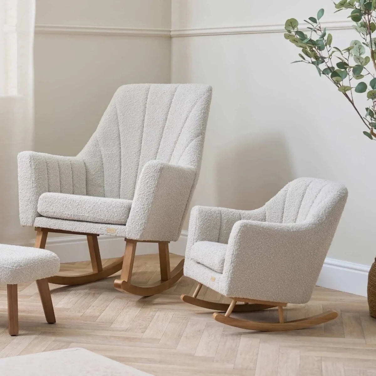 Two children’s light-cream boucle rocking chairs with curved wooden rockers and tufted back