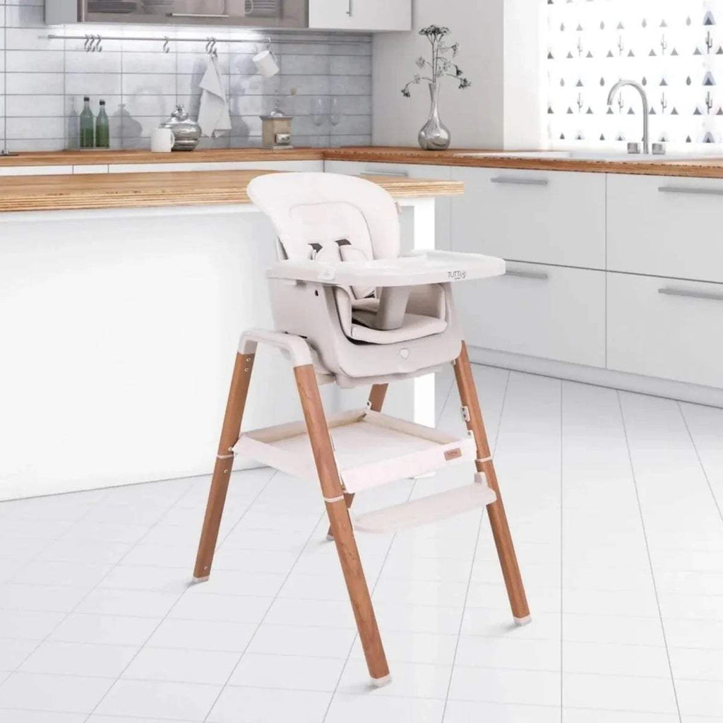 Tutti Bambini Nova highchair with ecru cushions and light wood frame, side view